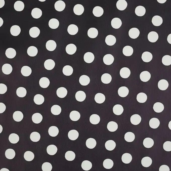 Tessuto impermeabile nero a pois bianchi
