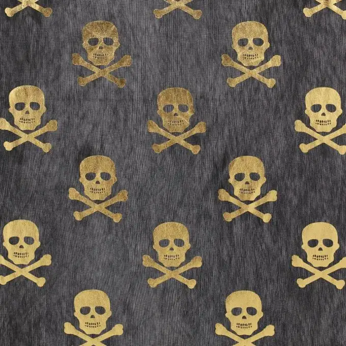 Tessuto nero teste di morto dorate