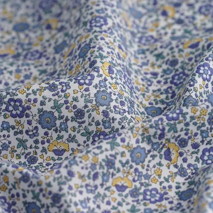 Tessuto batista cotone biologico piccoli fiori blu