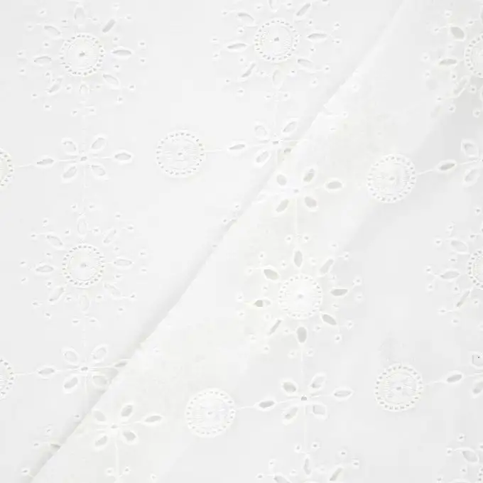 Tessuto velato ecru con motivi traforati