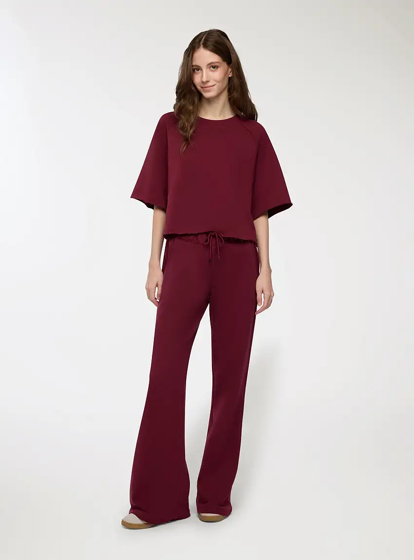 Pantaloni tuta a zampa vita bassa Bordeaux