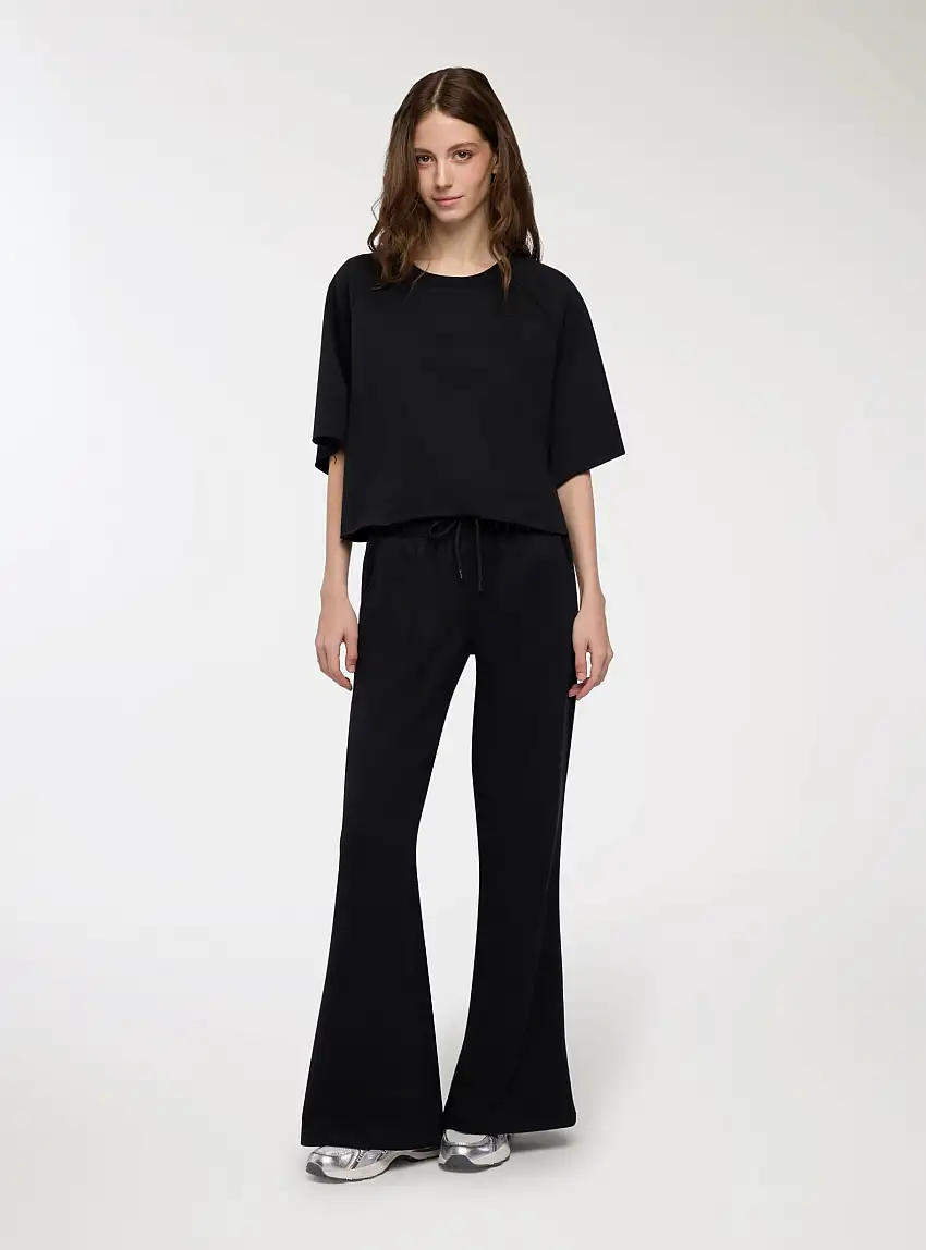 Pantaloni tuta a zampa vita bassa Nero