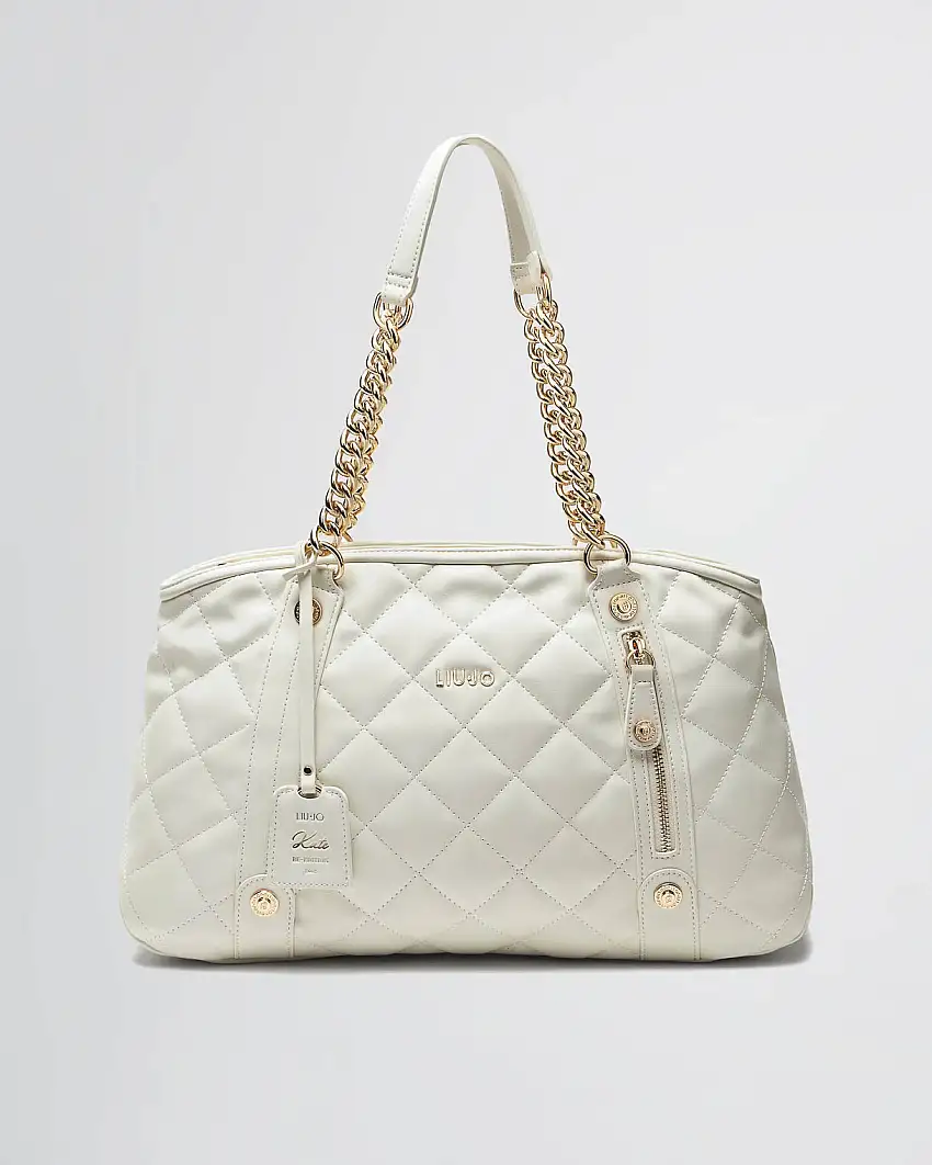 Borsa Kate a spalla color avorio misura grande in pelle nera matelassé logo in metallo e charm frontale