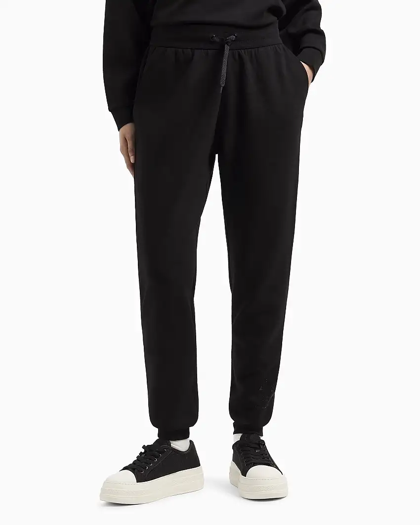 Joggers slim-fit neri in tessuto scuba con logo al fondo in strass applicati