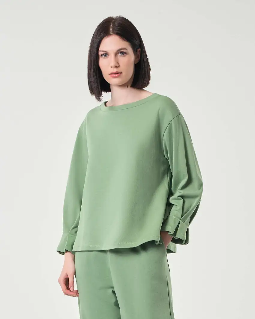 Felpa verde chiaro in cotone garzato con cucitura e motivo a pieghe sui polsini